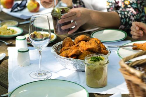 a table with a bowl of food and a glass of wine at Schloss Kapfenstein in Kapfenstein