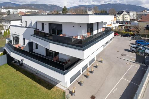 an aerial view of a white building with a balcony at Amaria Downtown Aparthotel Villach in Villach