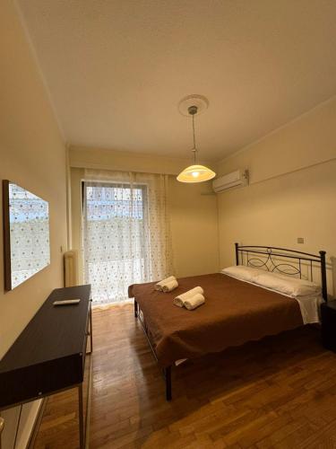 a bedroom with a bed and a desk and a window at NOX Apartment A4 in Chios
