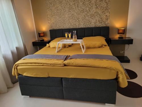 a bedroom with a large bed with a table on it at Ferienwohnung Neubauer in Bremerhaven