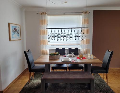 a dining room table with chairs and wine glasses at Ferienwohnung Neubauer in Bremerhaven