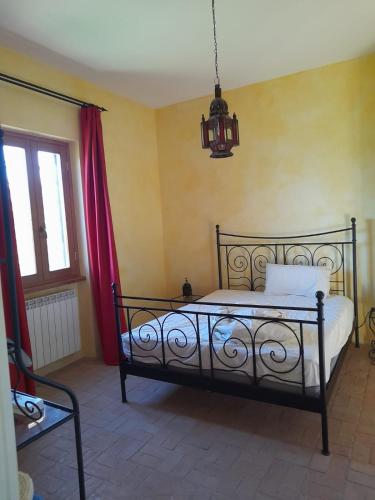 a bedroom with a bed and a chandelier at Villa Eliana Fregene in Fregene