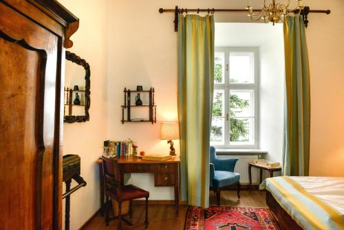 a bedroom with a desk and a bed and a window at Schloss Kapfenstein in Kapfenstein