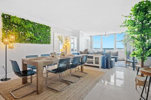 a dining room and living room with a table and chairs at Ocean Beach Condo 3BR On the Sand 505 in Fort Lauderdale