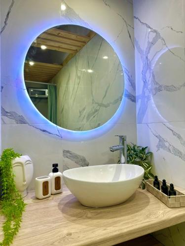 a bathroom with a bowl sink and a mirror at Peaceful Cottage House By The Sea - Private Garden in Análipsis