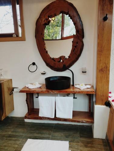 a bathroom with a sink and a mirror at Saguamby Mindo Lodge in Mindo
