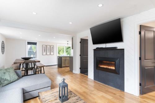 a living room with a couch and a fireplace at All New Retreat Walk to Village, Fire Pit, WiFi in Conway
