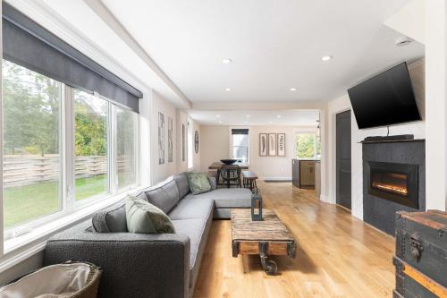a living room with a couch and a fireplace at All New Retreat Walk to Village, Fire Pit, WiFi in Conway