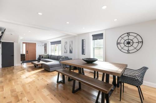 a living room with a table and a couch at All New Retreat Walk to Village, Fire Pit, WiFi in Conway