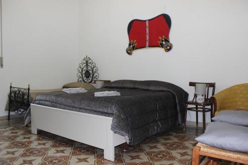 a bedroom with a bed with a blanket on it at Casa Vacanze Zarinu Orgosolo in Orgosolo