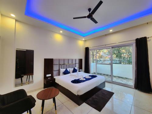 a bedroom with a bed with a blue ceiling at Raina's BnB in Solan