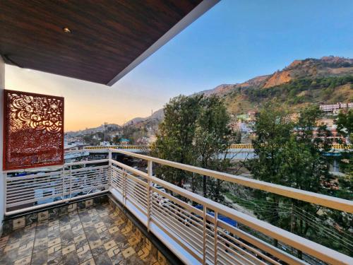 a balcony with a view of the mountains at Raina's BnB in Solan