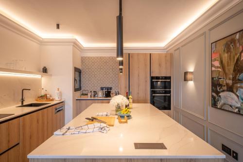a large kitchen with a large white counter top at 2br luxury design with sea views from every room in Sliema in Sliema