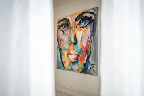 a painting of a woman on a wall at 2br luxury design with sea views from every room in Sliema in Sliema