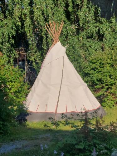 a painting of a teepee in the grass at Taideniityn Maa 1 - 4lle in Varkaus