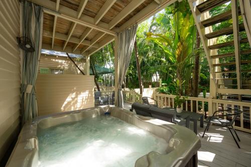a jacuzzi tub on a porch with a patio at Heron Hideaway in Key West