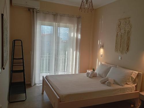 a bedroom with a bed with a ladder and a window at Elenas Garden in Kavos