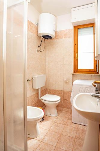 a bathroom with a toilet and a sink at La casa di Marcello in Orbetello