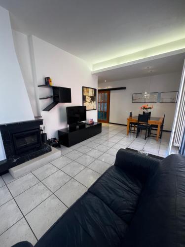 a living room with a couch and a fireplace at Rimini Casa Vacanze 2 in Rimini