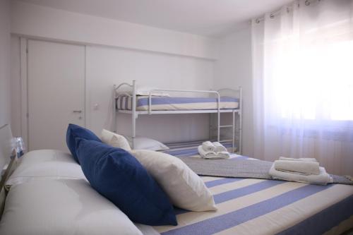a bedroom with two bunk beds with pillows at Rimini Casa Vacanze 2 in Rimini