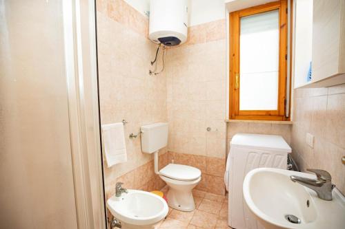 a small bathroom with a toilet and a sink at La casa di Marcello in Orbetello