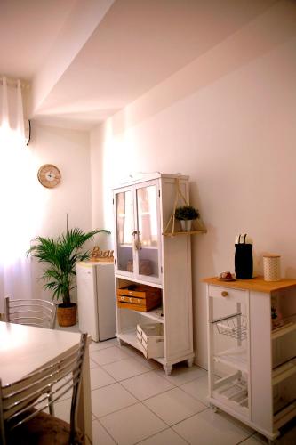 a kitchen with a white cabinet and a refrigerator at Rimini Casa Vacanze 2 in Rimini