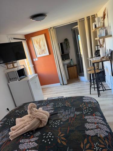 a bedroom with a bed with a towel on it at Le Cocon de la Baie in Pontorson