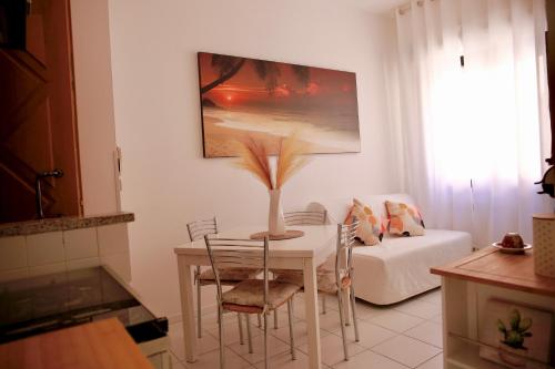 a living room with a table and a couch at Rimini Casa Vacanze 2 in Rimini