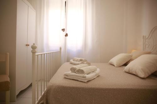 a bedroom with a bed with towels on it at Rimini Casa Vacanze 2 in Rimini