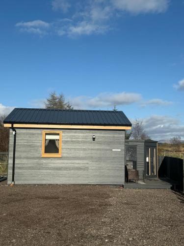 a large gray garage with a window on it at Ben Nevis Manor Studio with private Hot Tub in Fort William