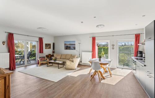 a kitchen and living room with a table and chairs at Landleben in Gransee
