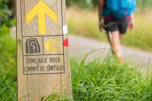 a sign on a trail with a person walking down a trail at Santiago Apartment in Caminha