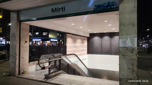 a store front with an escalator in front of a store at Metro Mirti Rome Suite in Rome
