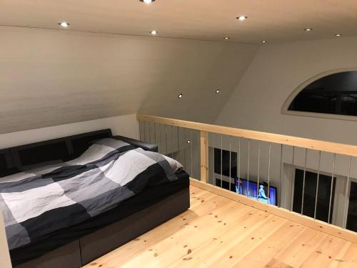 a bedroom with a bed and a wooden floor at 10 min walk from city center in Ribe