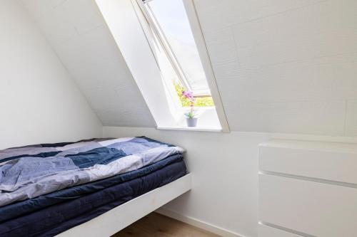 a bed in a room with a window at 10 min walk from city center in Ribe