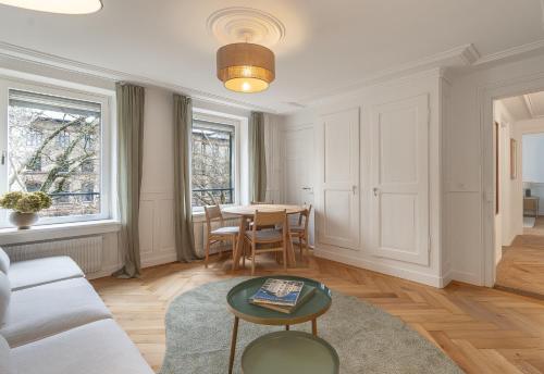 a living room with a table and a couch at Boho Suite in Zürich