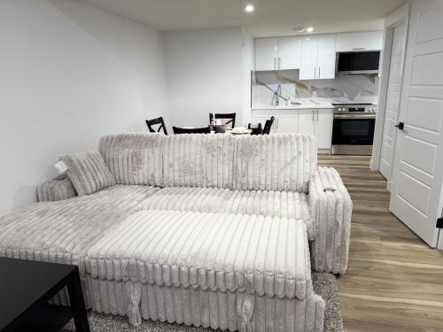 a living room with a couch and a table at Charming Basement Suite in Edmonton