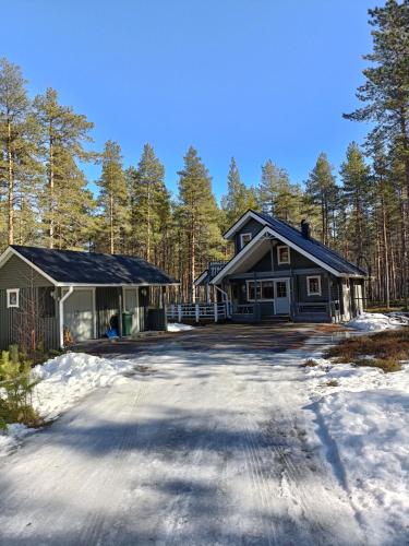 a house with a driveway in the snow at Villa Särkkä in Kalajoki
