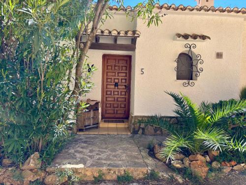 a house with a red door and some plants at Casa Halcón in Jávea