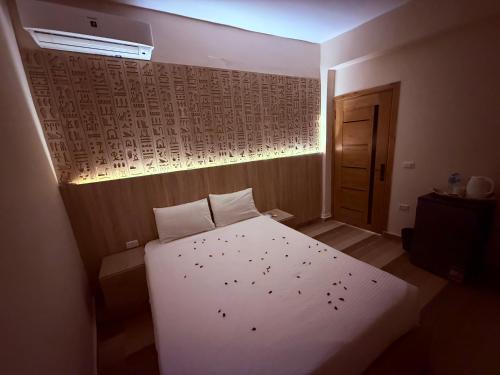 a small bedroom with a white bed in a room at Locanda pyramids view in Cairo