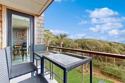 a porch with a table and chairs on a balcony at Shipwatch 2373 in Kiawah Island