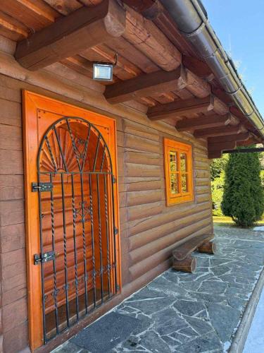 an entrance to a house with an orange door at Chata U Juraja in Hruštín