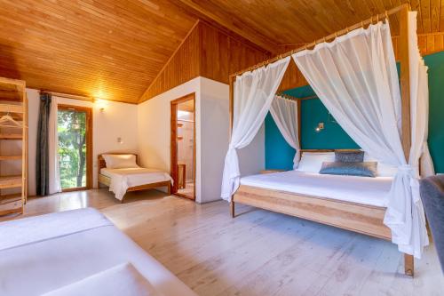 a bedroom with a bed and a wooden ceiling at Etenna Beach Bungalows in Cıralı