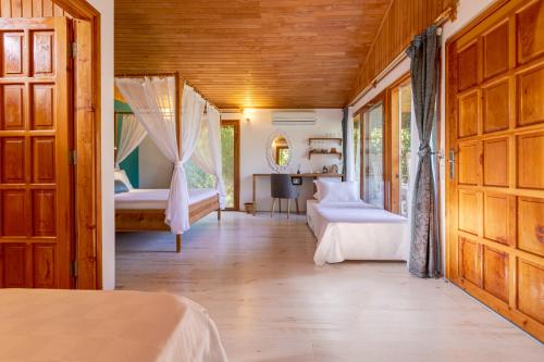 a bedroom with two beds and a desk at Etenna Beach Bungalows in Cıralı