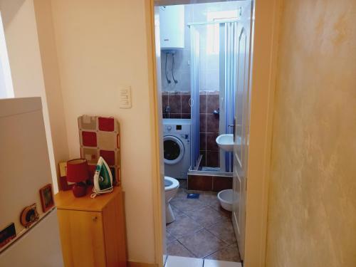 a bathroom with a toilet and a washing machine at B4 in Budva