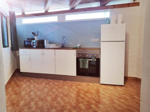a kitchen with a refrigerator and a stove at Casamaria in Tarajalejo