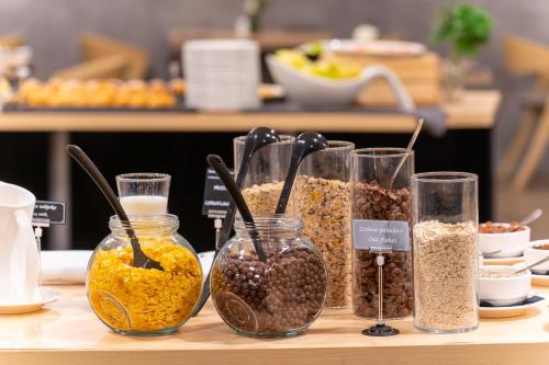 a table with several jars of different types of food at Hotel Academia in Zagreb