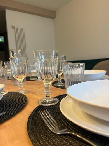 a wooden table with empty glasses and plates and forks at AL 31 Bg in Bergamo