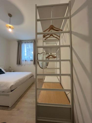 a shelf in a bedroom with a bed at AL 31 Bg in Bergamo