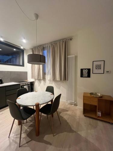 a kitchen and dining room with a table and chairs at AL 31 Bg in Bergamo